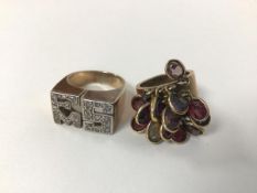 A gilt metal ring with a cluster of pendants, each with a coloured stone and another ring, with a