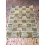 A hand crafted India cut and loop Tibet design rug, with multiple panels in tans (176cm x 121cm)