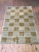 A hand crafted India cut and loop Tibet design rug, with multiple panels in tans (176cm x 121cm)