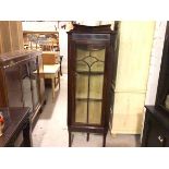 An Edwardian mahogany corner cabinet with ledge back and glazed astragal panel door enclosing
