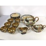 A 1940s/50s Japanese tea service with six teacups, all with gilt interiors, saucers, teapot,