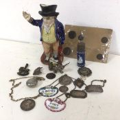A mixed lot including a 19thc Mr Pickwick toby jug (19cm), silver and enamelled bottle labels, a