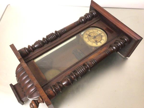 An Edwardian walnut cased cymbal gong Vienna style wall clock with arched glazed panel door