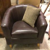 A modern brown hide tub chair with squab cushion on square tapered pine supports (75cm x 78cm x