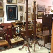 A pair of mahogany fluted column floor lamps raised on tripod carved acanthus leaf supports and claw