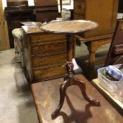 A modern mahogany pedestal wine table with circular beaded top, on turned column and tripod