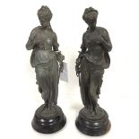 A pair of French style spelter figures, Summer and Spring, raised on circular treen bases (40cm x