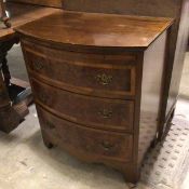 A mahogany reproduction bow front batchelor's style chest, with pull out slide above a satinwood and