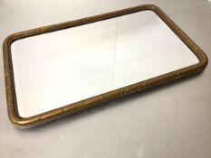 A 19thc gilt and beaded border rectangular wall mirror with rounded angles and bevelled plate (