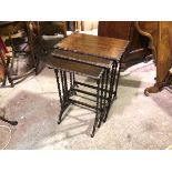 A 1920s oak nest of three coffee tables, the rectangular tops with scalloped border on barley