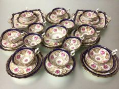 A Cauldon china thirty eight piece tea service including sugar basin, two cake plates, teacup,