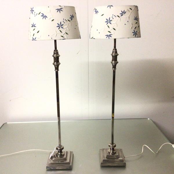 A pair of modern silvered finish square column lamps, on stepped bases, with linen embroidered