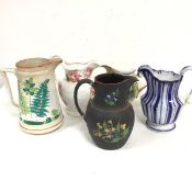 A collection of five various pottery jugs including a Wedgwood early 19thc black basalt