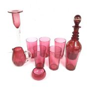 A set of six cranberry glass tapered tumblers, a flash glass scrolling neck spirit decanter, a
