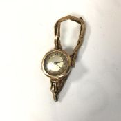 A lady's vintage 9ct gold wristwatch with silvered dial and arabic numerals, on 9ct gold