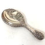 A Walker & Hall chased silver backed dressing table hand mirror with rose, leaf and scrolling border