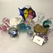 A group of ten various Caithness and other glass paperweights, a Murano style fish, a horn pistol