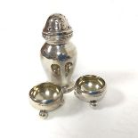 A pair of London silver circular cauldron style salts raised on bun feet (3cm x 5cm) and a London