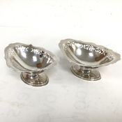 A pair of Sheffield silver navette shaped pierced bonbon dishes on oval stepped bases (8cm x 17cm