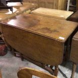 An oak drop leaf gateleg dining table with rounded angles, on turned baluster supports (top a/f) (