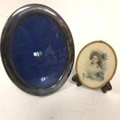 An Epns oval photograph frame (22cm x 17cm) on easel stand and an Edwardian oval brass mounted