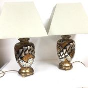 A pair of Art Deco inspired baluster vase ceramic table lamps, raised on gilded and silvered