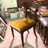 An early 19thc rosewood side chair with curved top rail and slip in seat, raised on turned tapered