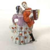 A Russian porcelain figure group, Accordian Player and Girl (17cm x 15cm), in traditional Russian