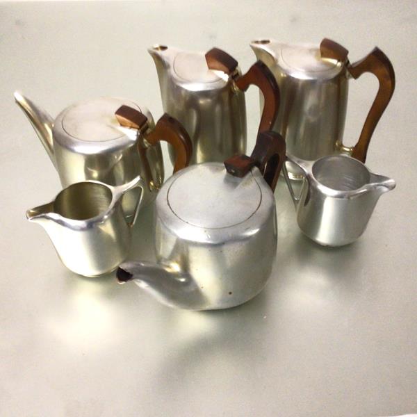A collection of piquot ware including two teapots, two hot water jugs and two milk jugs (6)