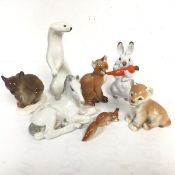 A group of Russian Lomonosov USSR china figures including a Brown Bear, a Mink in winter coat, a