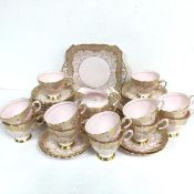 A thirty eight piece Tuscan china pink, gold and floral enamelled bordered tea service