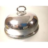 An Edwardian Epns oval dish cover with scroll handle to top, with engraved crest to front (including