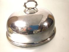 An Edwardian Epns oval dish cover with scroll handle to top, with engraved crest to front (including