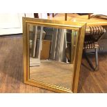 A rectangular gilt framed composition mirror (88cm x 72cm)