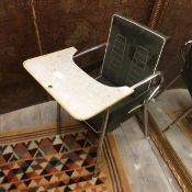 A vintage 1950s child's high chair with green vinyl back and formica table top, on chrome tubular