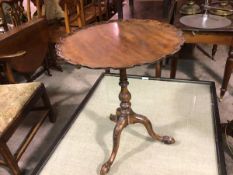 A Georgian style mahogany scalloped snap top occasional table, raised on turned carved baluster