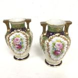 A pair of Noritake Worcester style baluster two handled vases decorated with handpainted floral