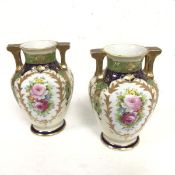 A pair of Noritake Worcester style baluster two handled vases decorated with handpainted floral