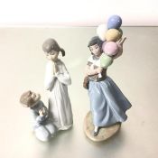 A Spanish Lladro porcelain group of two figures, The Balloon Seller and Prayers (28cm and 23cm)