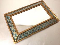 A modern rectangular gilt framed panel mirror with lotus stylised gilded and enamelled side