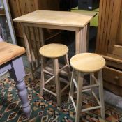 A pair of modern pine circular stools (61cm) and a pine breakfast style table (86cm x 81cm x