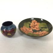 A Moorcroft miniature bud vase decorated with anenome design, blue ground and a Moorcroft shallow