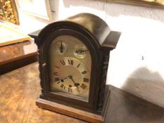 A late 19thc/early 20thc oak cased eight day German bracket clock, with silvered dial and
