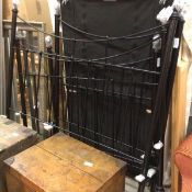 A black enamelled single Victorian style spar end bed complete with rails and slats and a single