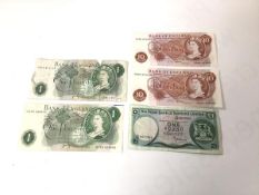 Two Bank of England ten shilling notes, uncirculated, a Bank of England one pound note (a/f) and