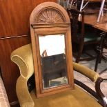 An Edwardian oak carved arched wall mirror with fan shell carved arched top and moulded