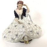 A Royal Dux porcelain figure of a Woman Seated, Reading (29cm x 34cm x 19cm)