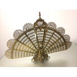 A cast brass Edwardian style peacock fan firescreen raised on cast acanthus leaf base (61cm x 85cm