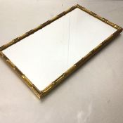 A rectangular gilt faux bamboo framed wall mirror (62cm x 36cm)