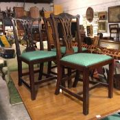 A set of six mahogany reproduction Chippendale style pierced and carved splat back dining chairs